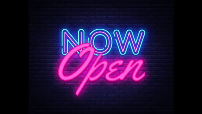 now open neon sign on brick wall background