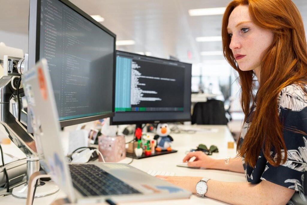 A woman in an office researching customer acquisition on her computer